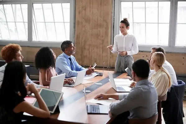 Diverse business team in a meeting room discussing lead generation call center strategies to improve customer acquisition and support.
