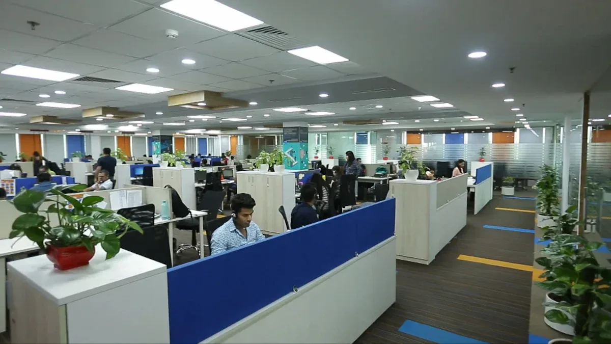 A modern call center office with multiple employees working in a professional environment. This showcases the in
frastructure behind call center outsourcing operations.

