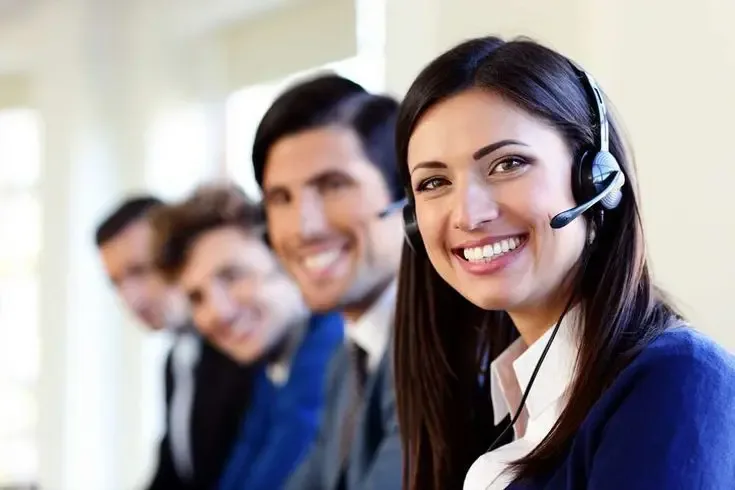 Happy female customer service agent wearing a headset, symbolizing positive customer service experience and professional support team.