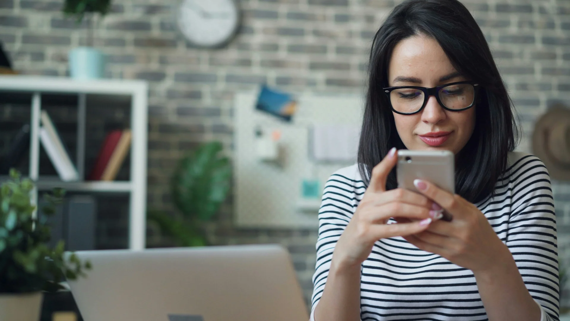 Customer checking her phone in a bright office