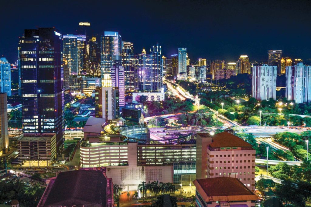 The city of Jakarta, Indonesia flourishes with life at night, demonstrating the grand success of its commercial sector and the advantage its provides to the country's economy.