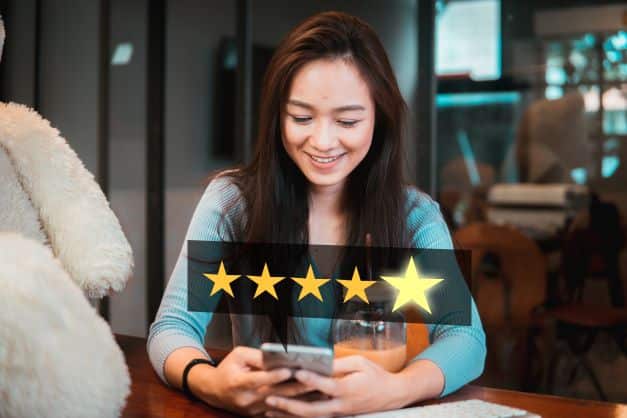A female eCommerce customer is leaving a five-star (5-star) review on Amazon for an Amazon Seller that provided her not only excellent outsourced customer service - but that also ensured that she got a high-quality product.