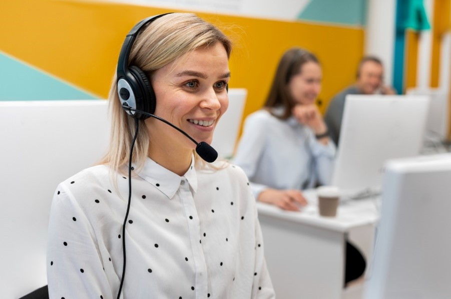 An Albanian call center rep from a multilingual call center within EMEA provides stellar pre-sales and after-sales customer support for an eCommerce brand that has been inspiring to beat the competition in Eastern Europe and build a long-term legacy; she smiles for the camera, showing that one of the hallmarks of outstanding customer engagement is a customer-centric attitude, leading to high customer retention.