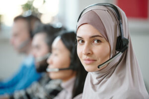 This picture demonstrates Moroccan customer service reps from an outsourcing Morocco call center smiling for the camera as they demonstrate superb pre-sale and during-sale customer support for big fashion company that specifically caters to French & English speaking customers.